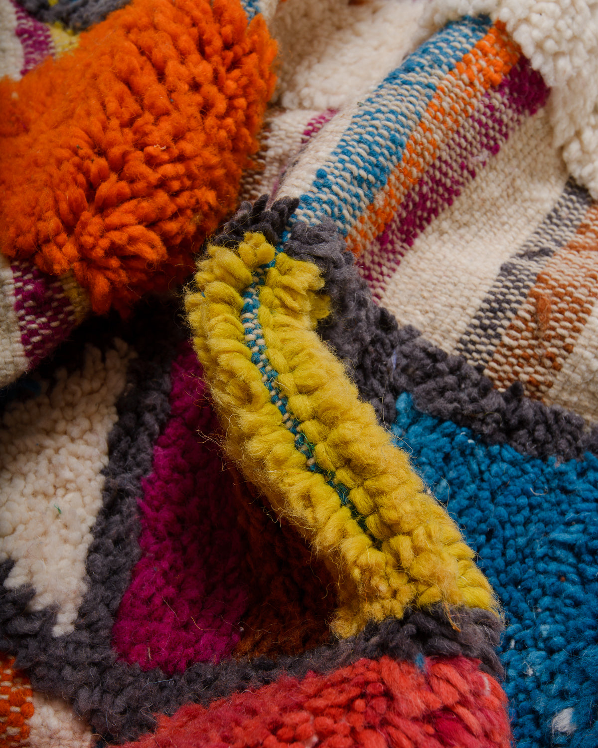 Detail of wool berber rug showing depth of pile and different coloured wool used.
